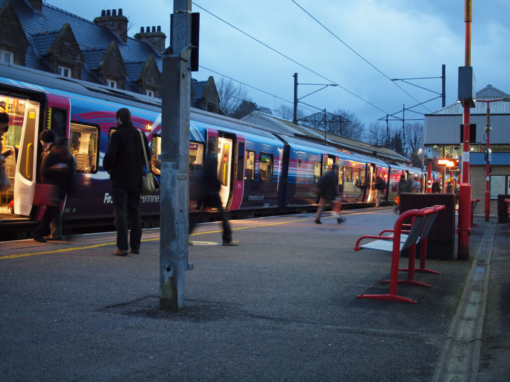 Early morning at Oxenholme and commuters hurry across to platform 3 for the train to Windermere