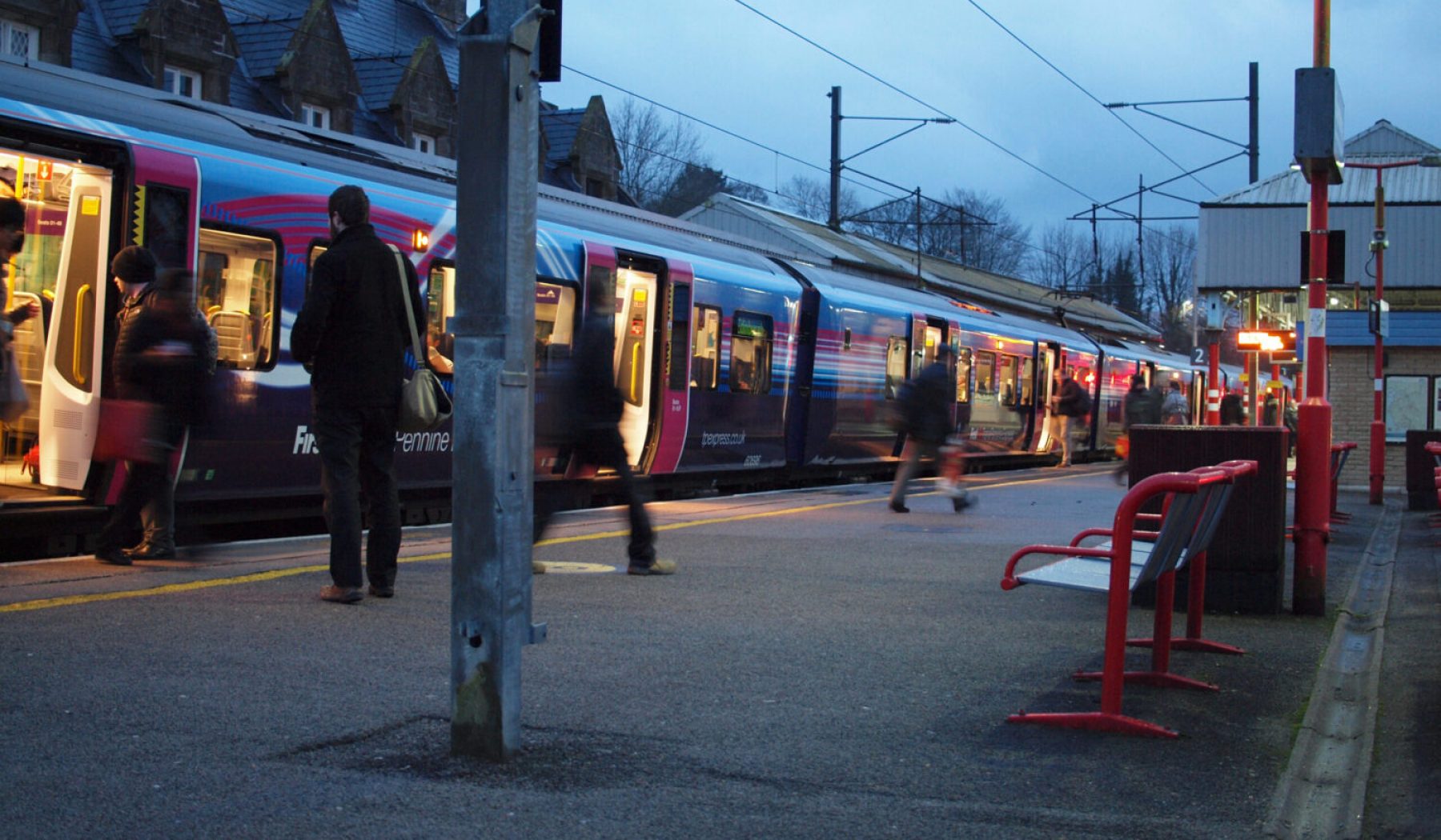 Early morning at Oxenholme and commuters hurry across to platform 3 for the train to Windermere